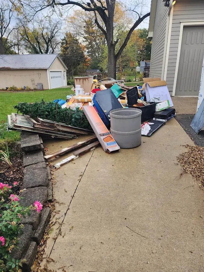 Dumpster being loaded with debris for 3 Yard Dumpster Rental in Rice Lake